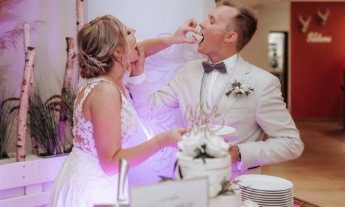 Braut und Bräutigam essen Hochzeitstorte